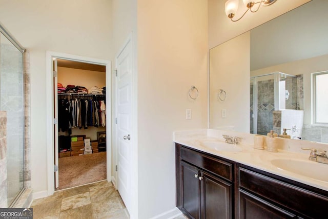 full bath featuring a sink, a shower stall, and double vanity