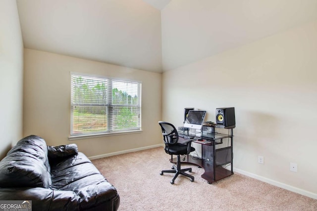 office space featuring carpet floors, baseboards, and vaulted ceiling