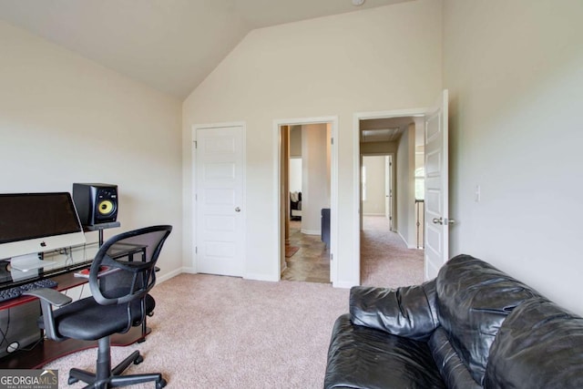 carpeted office space featuring high vaulted ceiling and baseboards