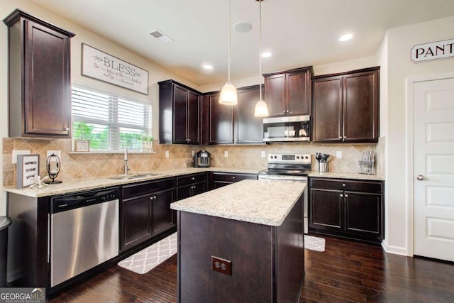 kitchen with visible vents, a sink, appliances with stainless steel finishes, dark brown cabinetry, and dark wood-type flooring