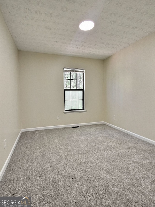 4460 Branchwood Ct, Loganville, GA 30052 - unfurnished room featuring carpet, visible vents, baseboards, and a textured ceiling