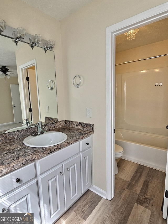 4460 Branchwood Ct, Loganville, GA 30052 - bathroom with toilet, ceiling fan, vanity, and wood finished floors
