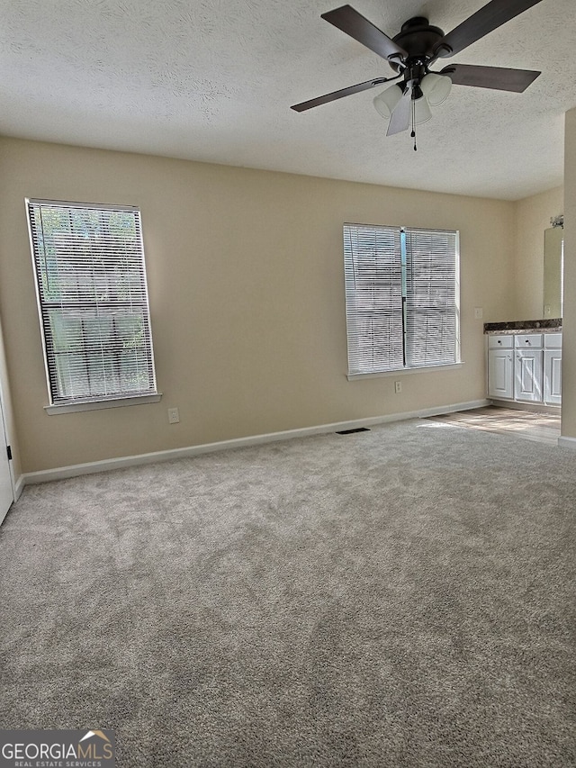 4460 Branchwood Ct, Loganville, GA 30052 - empty room featuring carpet flooring, a textured ceiling, baseboards, and ceiling fan