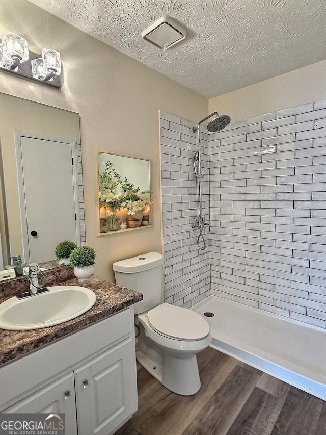 4460 Branchwood Ct, Loganville, GA 30052 - full bath featuring tiled shower, vanity, toilet, and wood finished floors