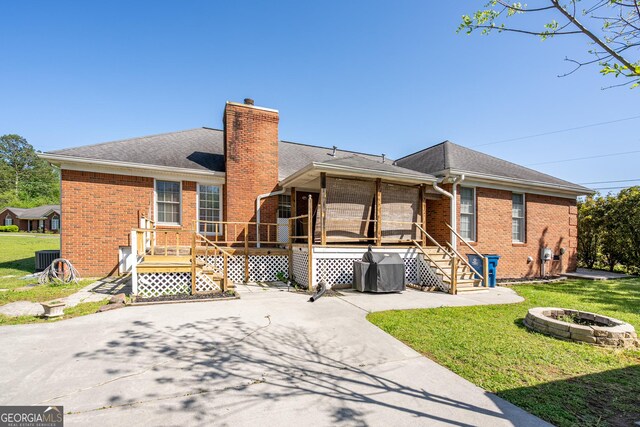 1 Graben Dr NW, Rome, GA 30165 - ranch-style home with an outdoor fire pit, a chimney, brick siding, a front lawn, and a wooden deck