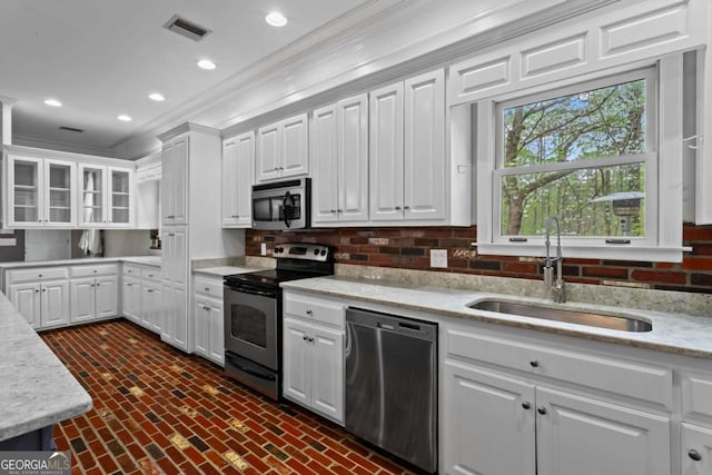 2455 Horseleg Creek Rd SW, Rome, GA 30165 - kitchen with white cabinets, a sink, ornamental molding, appliances with stainless steel finishes, and brick floor