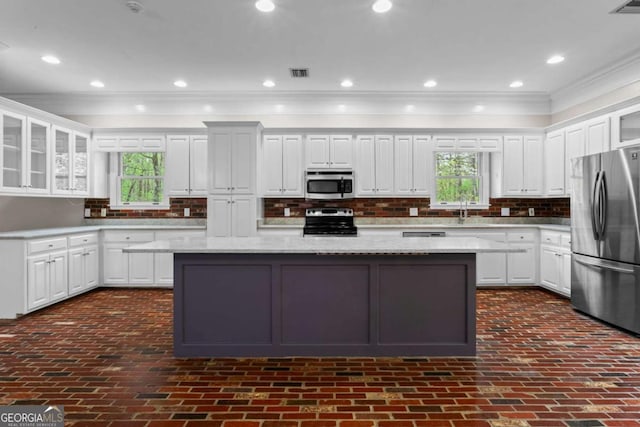 2455 Horseleg Creek Rd SW, Rome, GA 30165 - kitchen with visible vents, a center island, a sink, appliances with stainless steel finishes, and crown molding