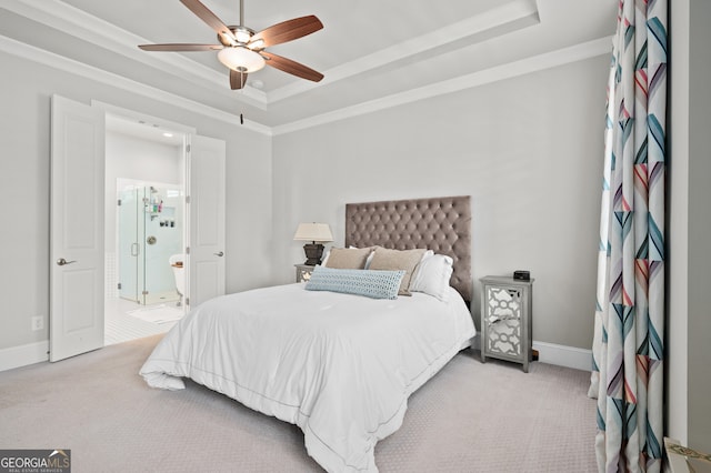 bedroom featuring baseboards, ornamental molding, a ceiling fan, a tray ceiling, and light carpet