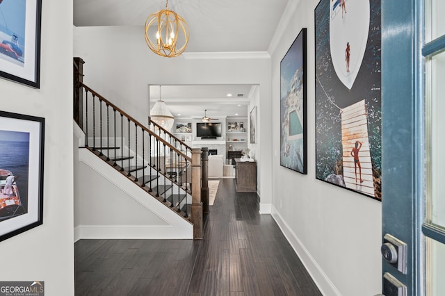 entrance foyer featuring crown molding, a fireplace, stairway, wood finished floors, and baseboards