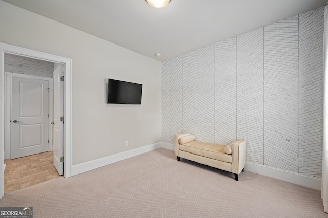 living area featuring baseboards and carpet flooring