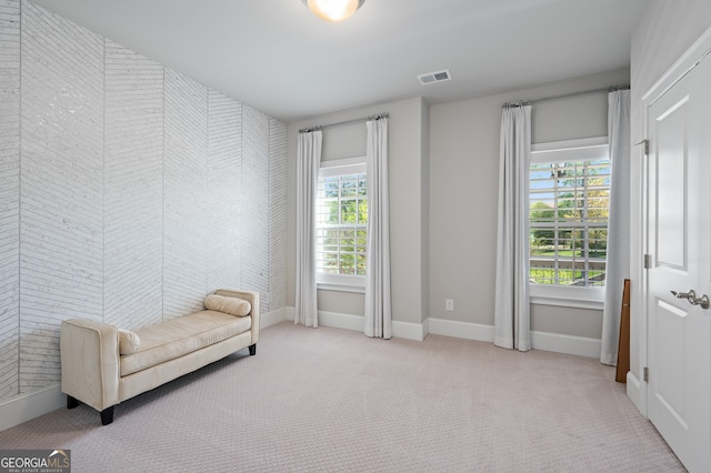 living area featuring visible vents, baseboards, and carpet floors