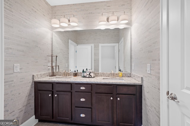 full bathroom featuring double vanity and a sink