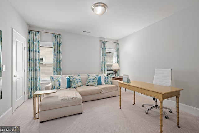 carpeted home office featuring visible vents and baseboards