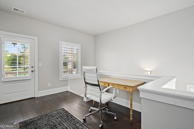 office area with dark wood-style flooring, baseboards, and visible vents