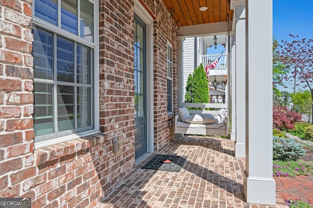 entrance to property with brick siding and covered porch
