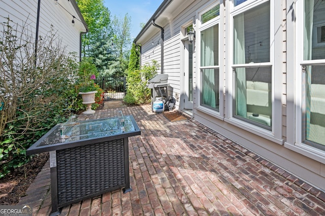 exterior space with a patio area, fence, and area for grilling
