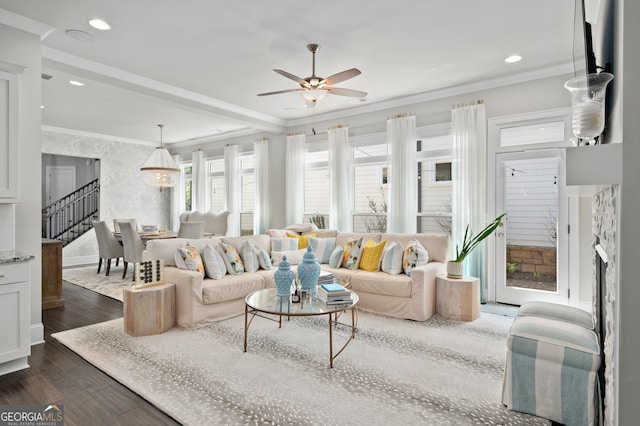 living area with crown molding, a ceiling fan, recessed lighting, stairs, and dark wood-style floors
