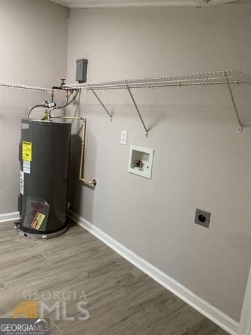 clothes washing area with water heater, laundry area, electric dryer hookup, and wood finished floors
