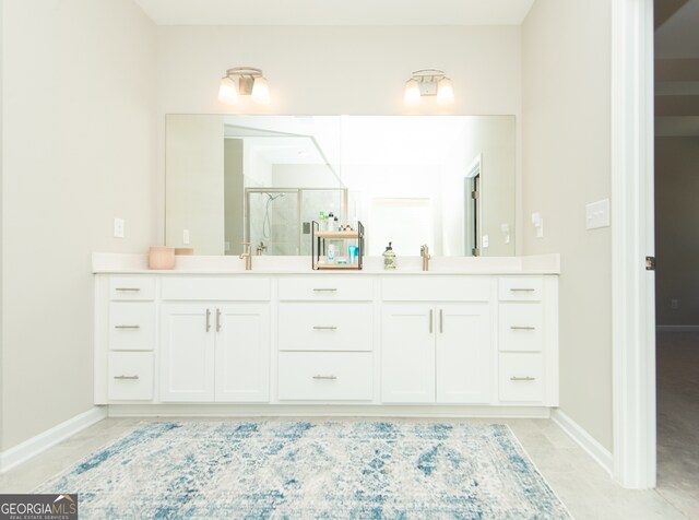 3495 Delegate Aly, Scottdale, GA 30079 - bathroom with baseboards, a sink, double vanity, and a stall shower
