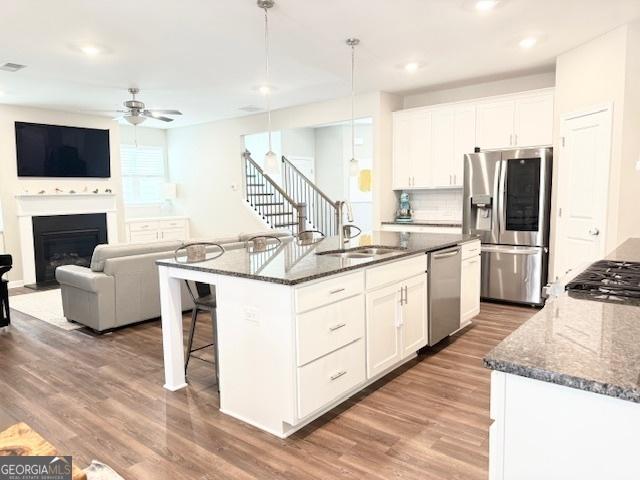 3495 Delegate Aly, Scottdale, GA 30079 - kitchen with a ceiling fan, wood finished floors, a sink, stainless steel appliances, and white cabinetry