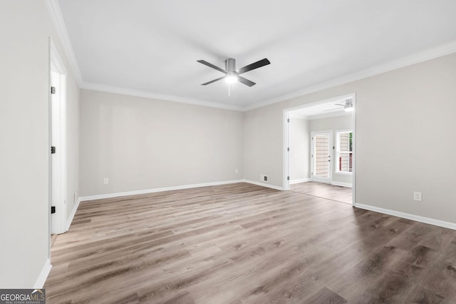spare room with crown molding, a ceiling fan, and wood finished floors