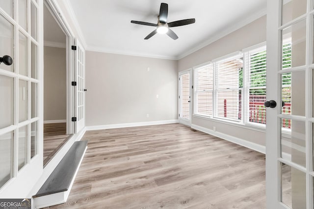spare room featuring french doors, wood finished floors, ceiling fan, and crown molding