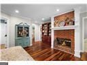 kitchen with recessed lighting, wood finished floors, and a fireplace