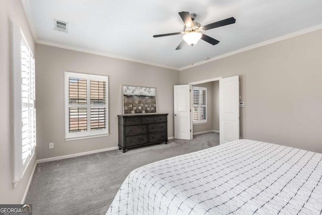 bedroom with light carpet, ornamental molding, multiple windows, and visible vents