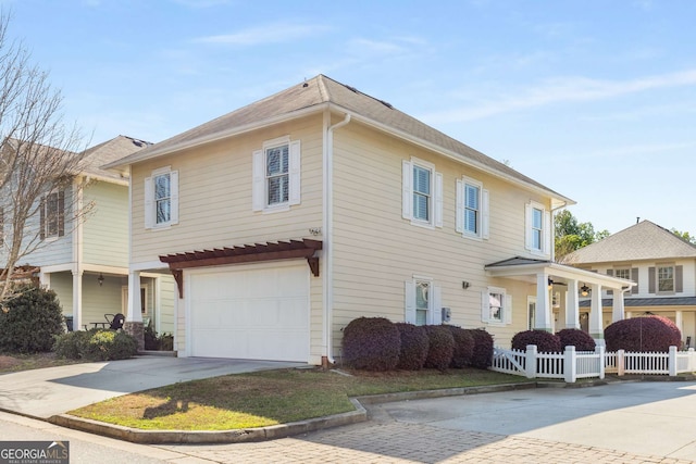 view of front of home featuring concrete driveway, a garage, and fence