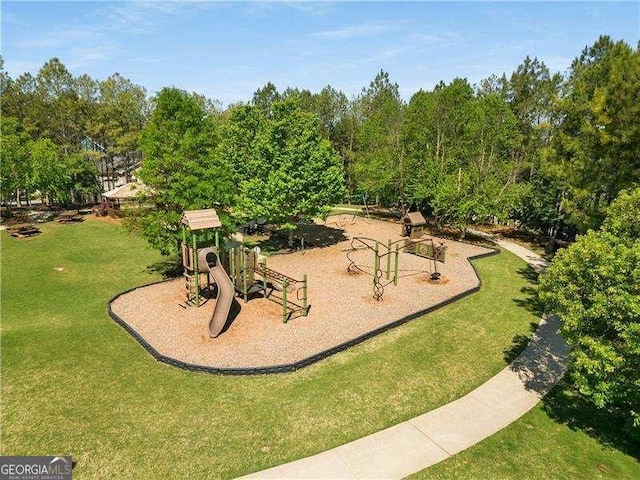 community jungle gym featuring a lawn