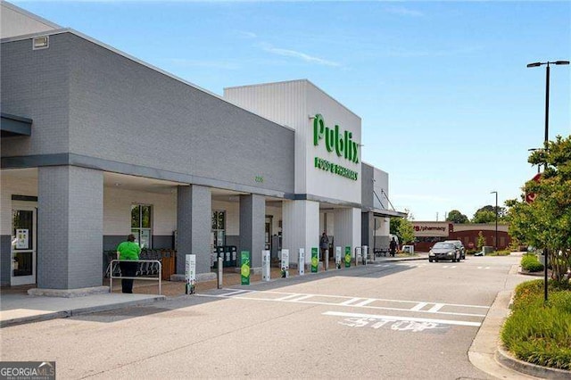 view of building exterior featuring uncovered parking