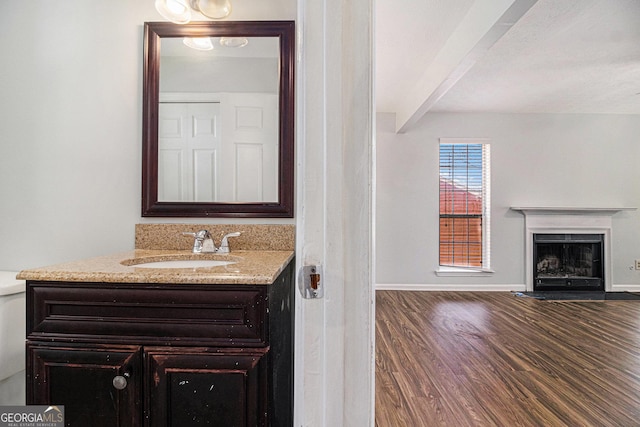 3742 Linecrest Rd, Ellenwood, GA 30294 - bathroom with a fireplace with flush hearth, baseboards, beamed ceiling, and wood finished floors
