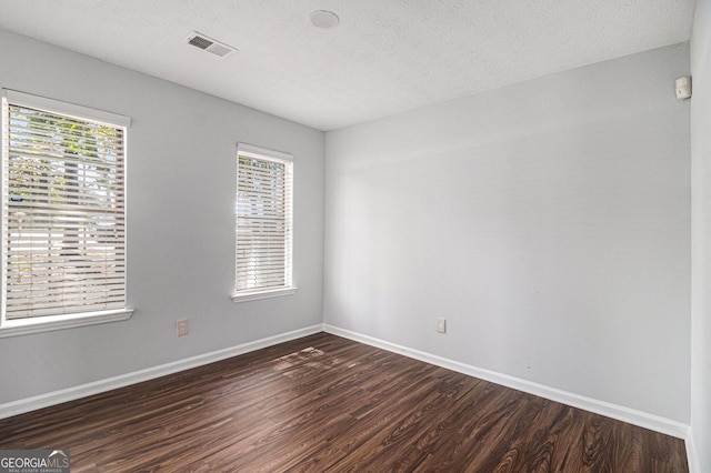 3742 Linecrest Rd, Ellenwood, GA 30294 - unfurnished room with a wealth of natural light, visible vents, baseboards, and dark wood-style floors
