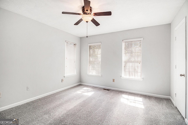 3742 Linecrest Rd, Ellenwood, GA 30294 - spare room featuring carpet floors, baseboards, a ceiling fan, and visible vents