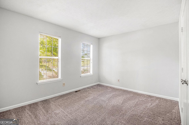 3742 Linecrest Rd, Ellenwood, GA 30294 - spare room featuring visible vents, a textured ceiling, baseboards, and carpet floors