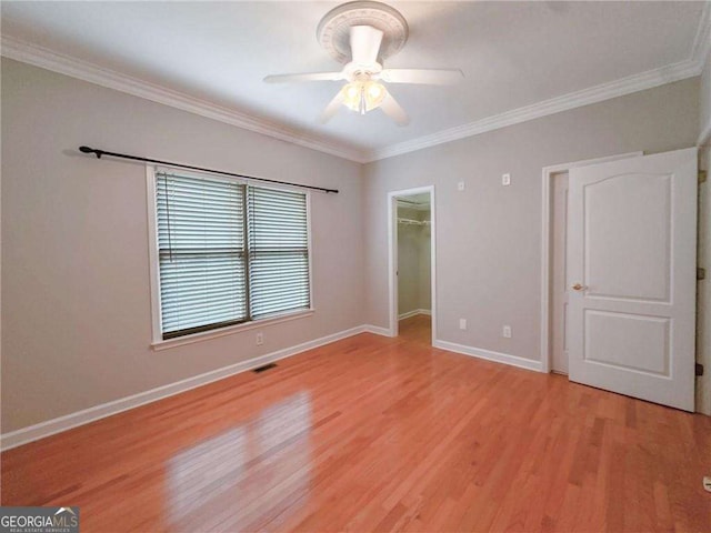 3195 Vickery Dr NE, Marietta, GA 30066 - unfurnished bedroom with ornamental molding, baseboards, light wood-type flooring, and visible vents