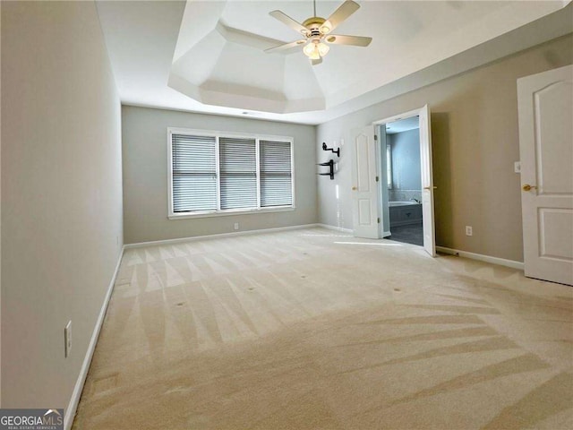 3195 Vickery Dr NE, Marietta, GA 30066 - unfurnished bedroom featuring a tray ceiling, carpet, ensuite bathroom, and baseboards
