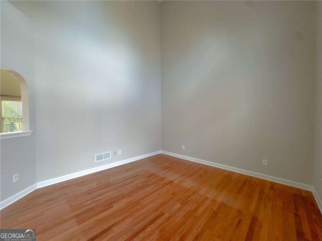 3195 Vickery Dr NE, Marietta, GA 30066 - spare room with visible vents, light wood-style flooring, arched walkways, and baseboards