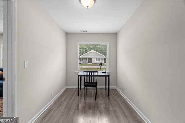 dining area featuring baseboards, visible vents, and wood finished floors