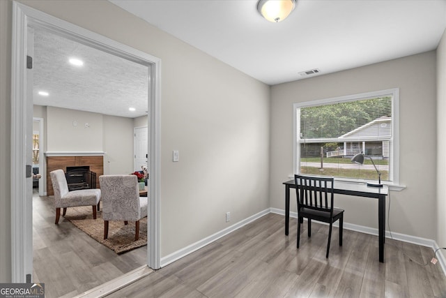 office featuring baseboards, recessed lighting, light wood finished floors, and visible vents
