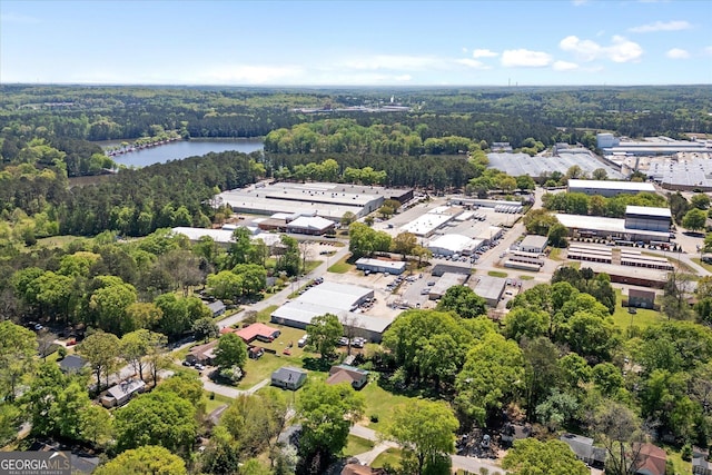 aerial view featuring a wooded view and a water view