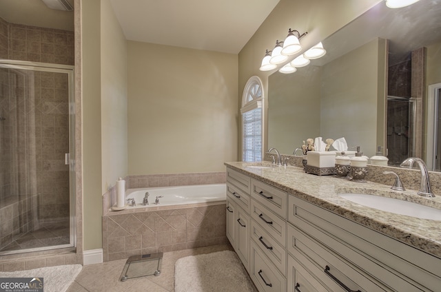 bathroom featuring a sink, a bath, tile patterned flooring, and a stall shower