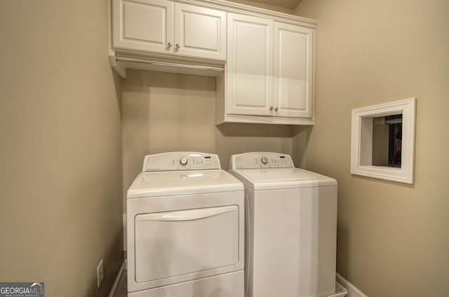 laundry area featuring washer and clothes dryer, baseboards, and cabinet space