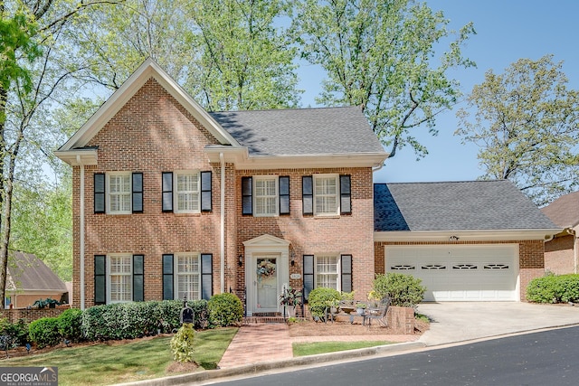 1826 Bedfordshire Ct, Decatur, GA 30033 - view of front facade with brick siding, a garage, driveway, and a shingled roof