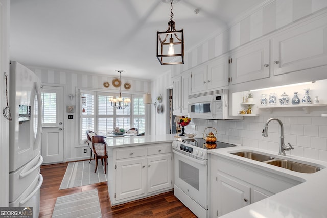 1826 Bedfordshire Ct, Decatur, GA 30033 - kitchen with white appliances, a sink, a peninsula, white cabinetry, and wallpapered walls