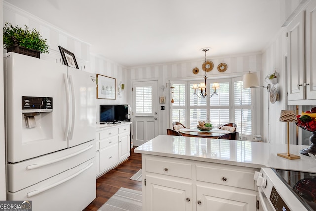 1826 Bedfordshire Ct, Decatur, GA 30033 - kitchen featuring white fridge with ice dispenser, a chandelier, dark wood-type flooring, ornamental molding, and white cabinetry