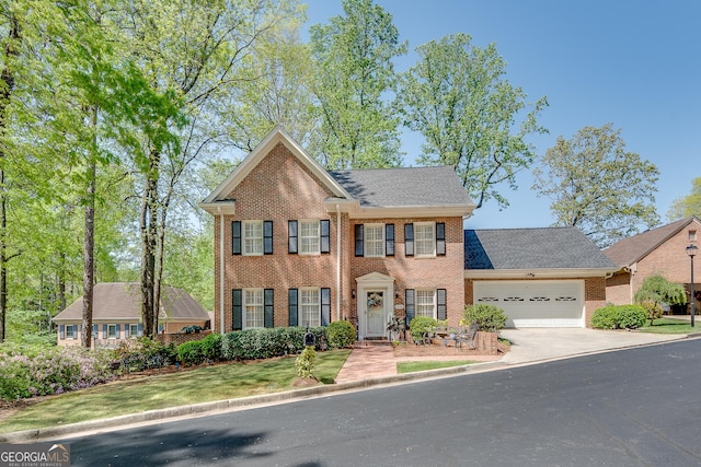 1826 Bedfordshire Ct, Decatur, GA 30033 - view of front of house featuring brick siding, a garage, driveway, a shingled roof, and a front yard