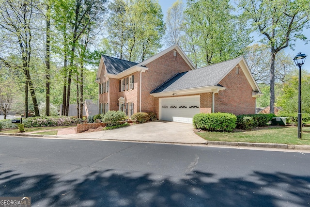 1826 Bedfordshire Ct, Decatur, GA 30033 - view of front of house featuring brick siding, a garage, and driveway