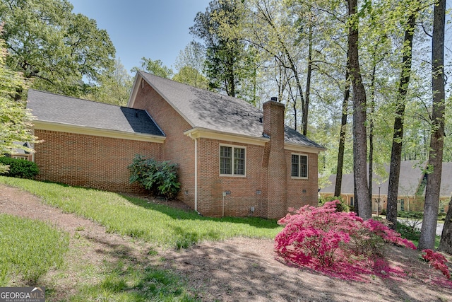 1826 Bedfordshire Ct, Decatur, GA 30033 - view of home's exterior featuring brick siding, a chimney, crawl space, and a shingled roof