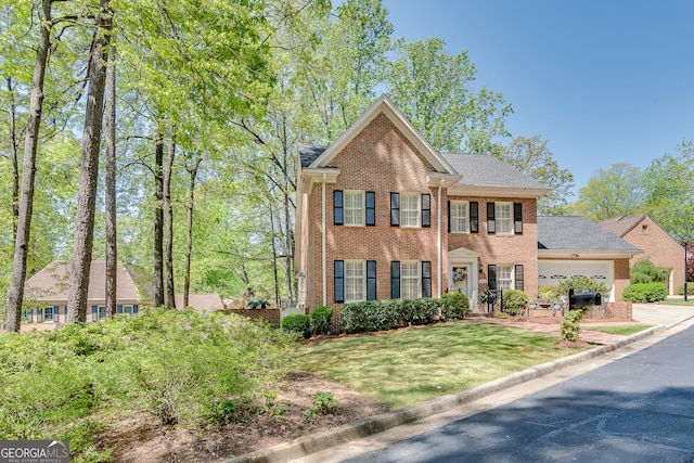 1826 Bedfordshire Ct, Decatur, GA 30033 - view of front of property featuring brick siding, an attached garage, driveway, a front yard, and a shingled roof